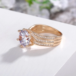 Macro side view of rose gold engagement ring with round zircon and classic six-prong setting