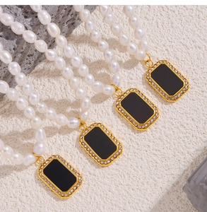 Macro detail of freshwater pearl necklace with black square pendant and diamond inlay