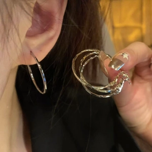 Chic silver hoop earrings with a minimalist metal design shown on a model