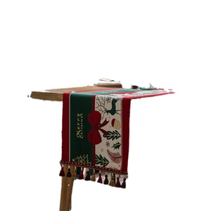 Festive Christmas table runner with red and green jacquard deer patterns and tassels