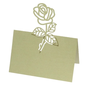 Macro detail of laser-cut rose design on light olive gold pearlescent table place card