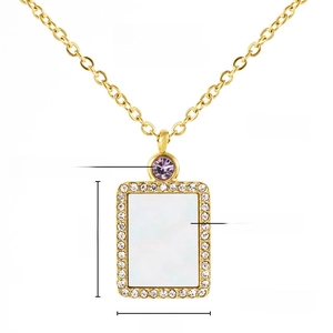 Detail of 18K gold plated stainless steel necklace with natural shell and purple zircon