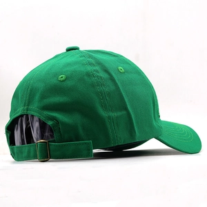 Detail of bright green cotton baseball cap showing back metal buckle and twill fabric texture