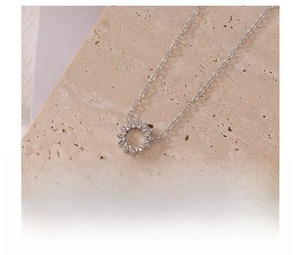Detail view of silver sunflower zircon pendant on stone with vacuum plating specs