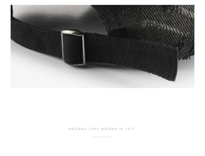 Detailed macro of vintage washed black baseball cap with antique bronze metal buckle strap
