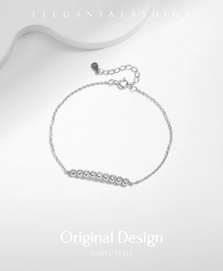 Close-up of S925 sterling silver bracelet with nine round cubic zirconia and extender chain