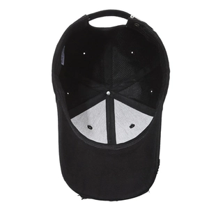 Inside view of a black cotton baseball cap showing white lining and adjustable metal buckle