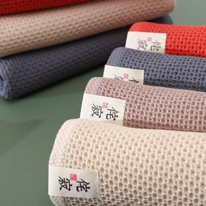 Absorbent waffle weave cotton towels in beige, pink, grey blue and red colors