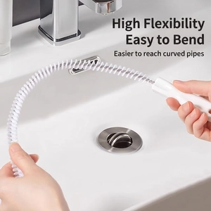 Highly flexible white drain cleaning brush shown bending easily for pipe clearance