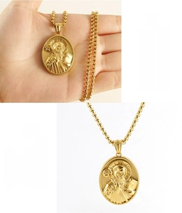 Macro shot of 18k gold-plated St. Benedict relief pendant with eco-friendly stainless steel