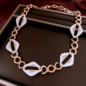 Detailed close-up of a vintage geometric necklace with white diamond-set rhombus accents