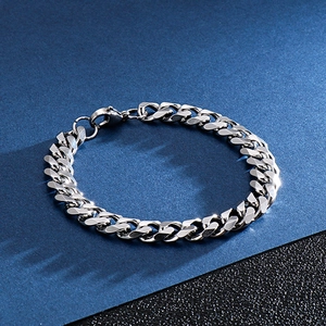 Detailed close-up of polished silver stainless steel Cuban link bracelet with lobster clasp
