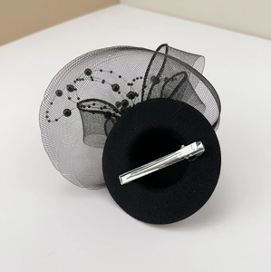 Vintage black mini top hat with mesh veil and beads featuring a metal crocodile clip