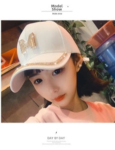 White baseball cap with gold rhinestone M letter logo and crystal embellished brim edge
