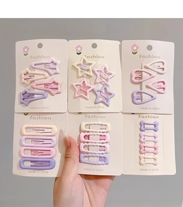Close-up of colorful star and heart hair clips in macaron shades for kids fashion