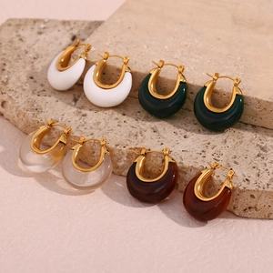 Close-up of set of four U-shaped hoop earrings in gold with colorful resin accents