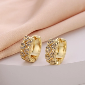 Detailed close-up of golden heart-shaped hoop earrings with micro-pave white zircon stones