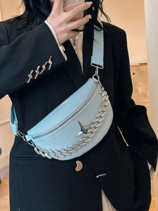 Detail of light blue lychee leather crescent bag with silver chain and star charm