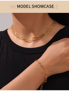 Detailed model shot of gold multi-layer necklace and bracelet set with colorful beads