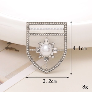 Detail of silver shield brooch with large pearls and crystals measuring 4.1cm by 3.2cm