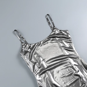 Detailed close-up of silver metallic fabric with shimmering finish on a slim dress