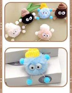 Close-up of colorful plush doll charms with big eyes and knit hats for shoe DIY decor