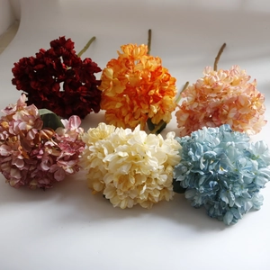 Detail showing six assorted artificial hydrangea heads in vintage oil painting colors