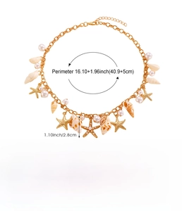 Detail of bohemian gold shell necklace with white pearls and starfish charms