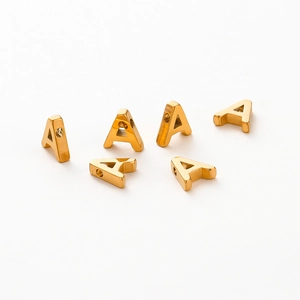 Macro shot of 1.8mm hole gold-plated letter A beads for DIY jewelry making