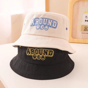 Detail of stacked cotton bucket hats with AROUND embroidery and smile icons