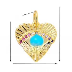 Macro detail of gold plated heart evil eye charm showing 13x17mm dimensions and crystals