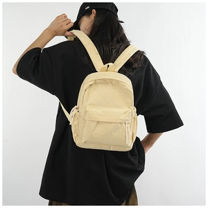 Detailed texture of yellow corduroy fabric on a large capacity stylish backpack