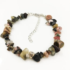 Detailed macro view of irregular natural mineral beads bracelet with silver lobster clasp