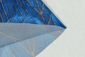 Macro detail of dark blue mesh fabric with golden metallic thread embroidery and texture