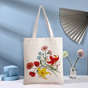 Floral canvas tote bag in off-white featuring colorful botanical prints and top handles