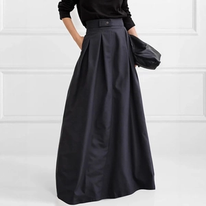 Detail of high waisted pleated A-line maxi skirt featuring decorative buttons on the waist
