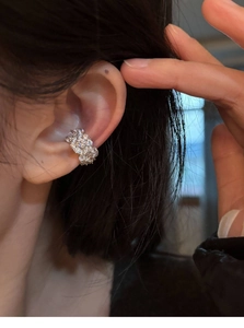 Detailed view of silver zircon ear cuff worn on ear bone with sparkling pavé crystals