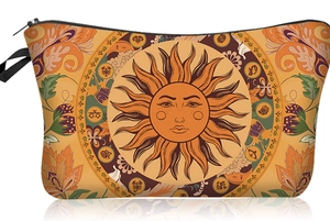 Macro detail of the vintage sun pattern and black zipper on this floral makeup bag