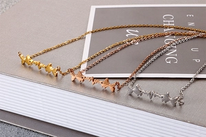 Detail of dog and heartbeat necklaces in gold, silver, and rose gold finishes