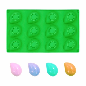 Detailed view of 12-cavity silicone banana mousse mold with multi-colored cake samples