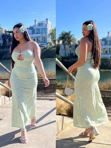 Light green cutout strapless maxi dress with metal ring detail shown outdoors
