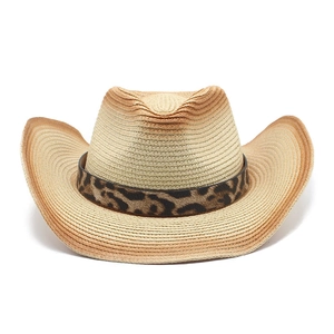 Close-up of gradient straw cowboy hat featuring a leopard print decorative band