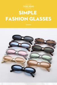 Flat lay of multiple retro oval sunglasses in diverse colors with a minimalist frame design