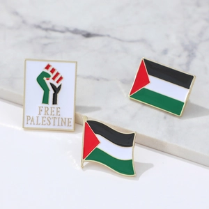 Free Palestine flag enamel lapel pin set with 3 metal badges on marble background