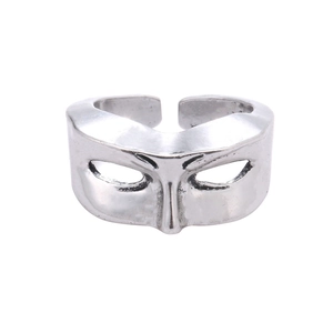 Close-up of vintage silver mask ring showing intricate hip-hop style metal textures