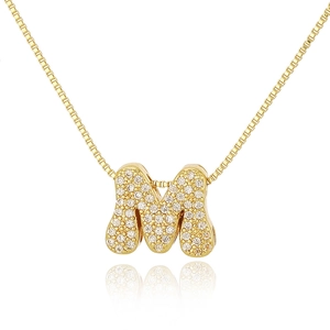 Close-up of gold box chain necklace with a crystal-encrusted letter M pendant
