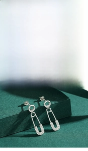 Detail shot of S925 sterling silver safety pin earrings with micro-pave cubic zirconia