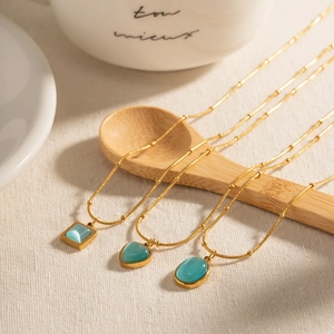 Elegant gold necklaces with blue cat eye pendants in square heart and oval shapes