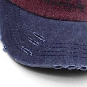 Close-up of distressed cotton baseball cap brim with vintage embroidery and torn details