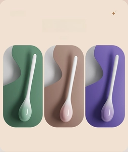 Modern toilet brush set in green, pink and purple with sleek long handles and bases